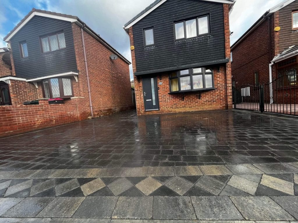 New block paving driveway with decorative diamond pattern edging outside semi-detached brick house